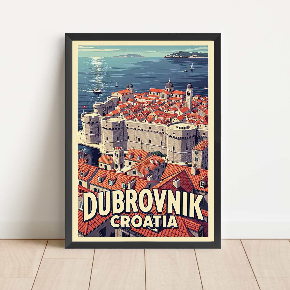 A framed travel poster of Dubrovnik, Croatia, leaning against a white wall on a light wood floor. The poster features a retro-style illustration of the city's red-roofed buildings and sea, with 'DUBROVNIK CROATIA' written in bold text at the bottom.