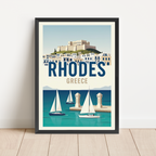 A framed travel poster of Rhodes, Greece, leaning against a white wall on a light wood floor. The poster features a retro-style illustration of the Acropolis, white buildings with blue trim, blue water, and several white sailboats under a pale blue sky.